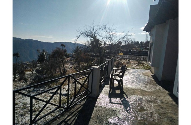 Beautiful cottage in nature's lap. Beautiful view of snow laden himalayan peaks.