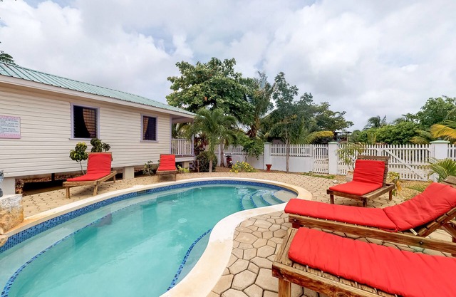 Cabana with a porch, hammock, & view of the pool & grilling area