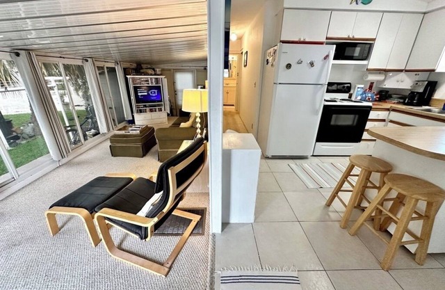 charming 1-bedroom, 1-bathroom beach bungalow is nestled on a spacious corner lot