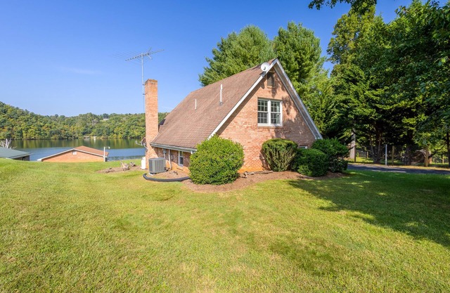Charming lakefront retreat with cozy interiors, private dock, fire pit, and breathtaking water view
