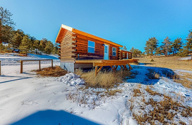 Charming log cabin with mountain views on 1,800-acre working ranch