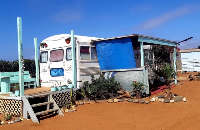 Cozy converted bus located 10 min walk from the beach .
