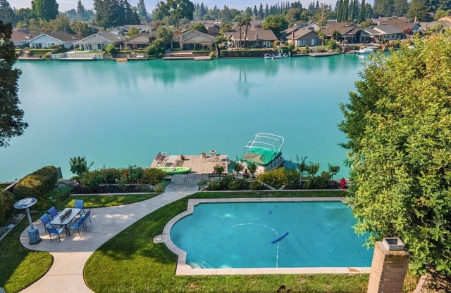 Cozy Home on a Lake and a sparkling pool with lush garden and Dock!
