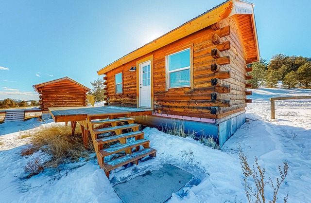 Cozy log cabin on 1,800-acre ranch with meadow/mountain views & animals