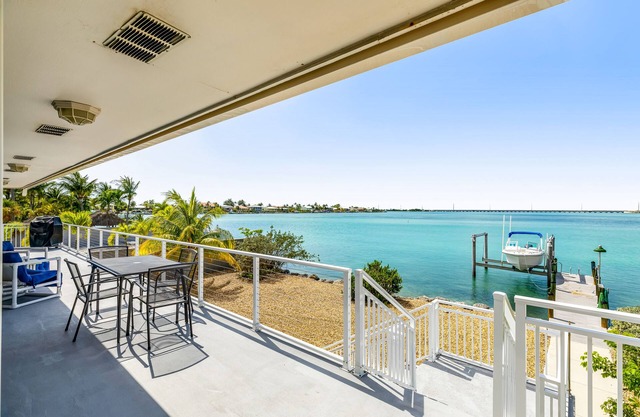 Dog-friendly beach escape with dock, furnished deck & bay views