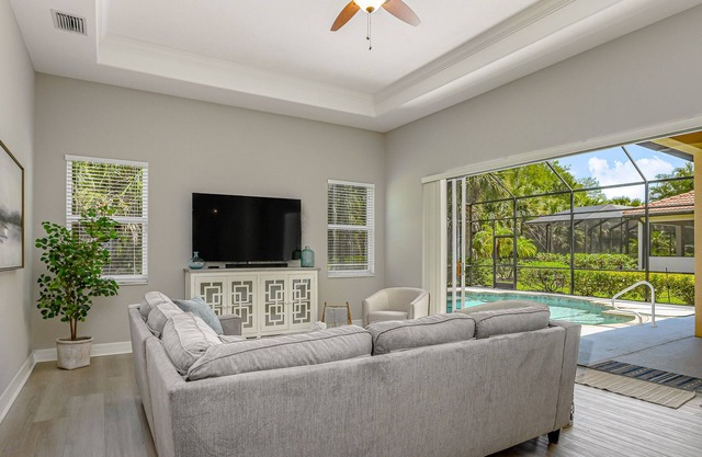 Dog-friendly home close to beach with screened patio & pool, & central AC