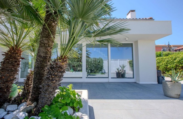 Elegant beachfront villa with jacuzzi, garden, and panoramic terrace.