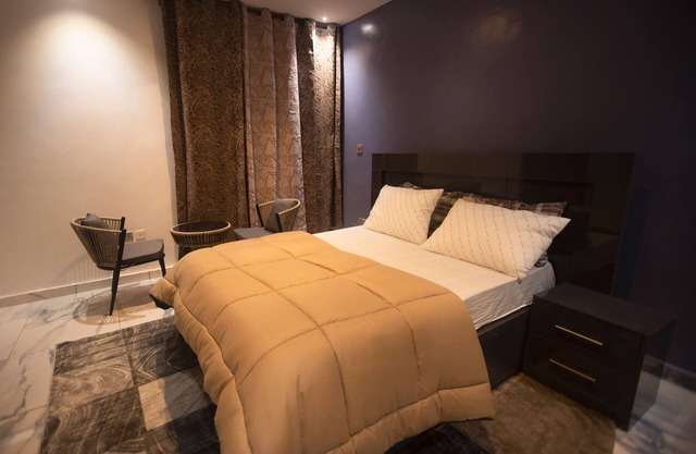 Exec 2BR Aptmt with modern kitchen, WiFi, cozy bedrooms, study area, and hall