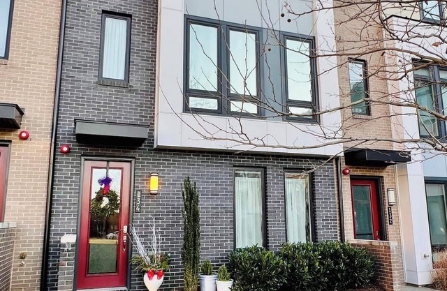 Four-level modern townhome with two grand pianos.