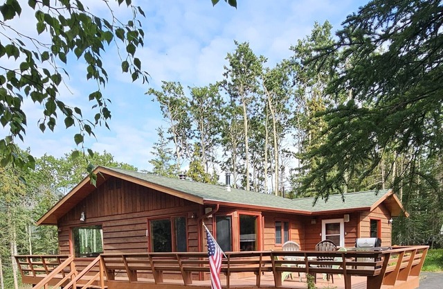 Home nestled in a private forest setting, mountain views, walk to Kenai Lake.