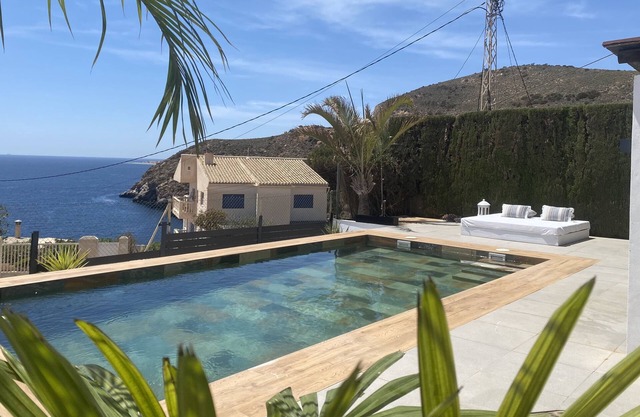 House located on a cliff in the Mediterranean Sea.
