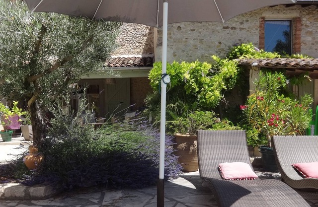 In a green setting, charming cottage with pool