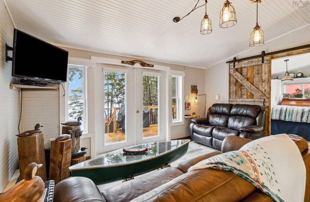 Lakefront cottage with sandy beach, great decks, beautiful sunrise.
