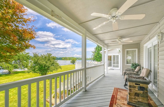 Lakefront retreat with a large yard, stone fire pit, gazebo, deck, & dock