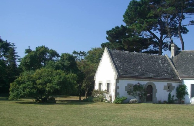 Little house in a garden in front of the sea