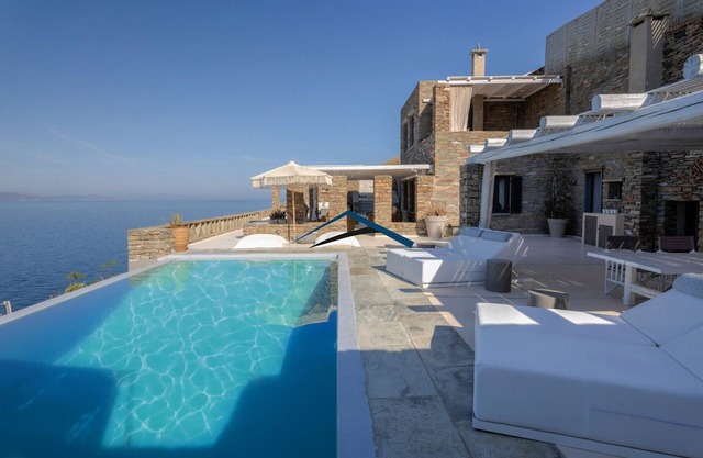 Luxurious villa on the watefront with a swimming pool & steps leading to the sea
