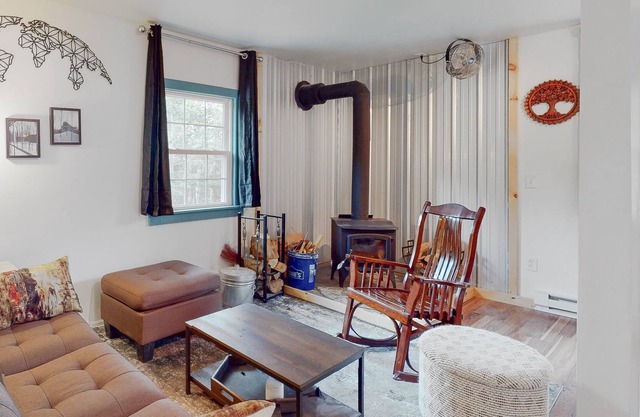 Secluded, dog-friendly cabin with a deck, large yard, firepit, & wood stove