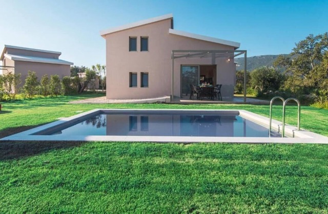 The villa's large private garden leads directly to the outdoor private pool.