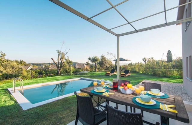 The villa's large private garden leads directly to the outdoor private pool.