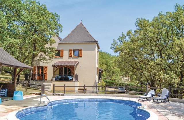 This modern house in traditional architectural style stands on an extensive, tree-filled plot surrou