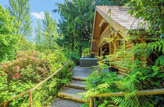 Timber lodge set in an elevated position with views of the lake.