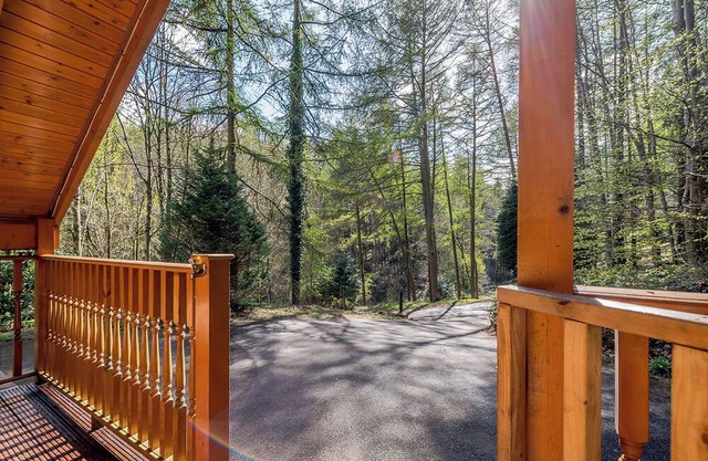 Timber lodge set in an elevated position with views of the lake.
