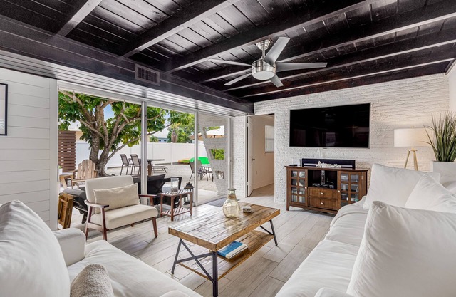 Trendy canal-front home with dock, full kitchen, central AC, & washer/dryer