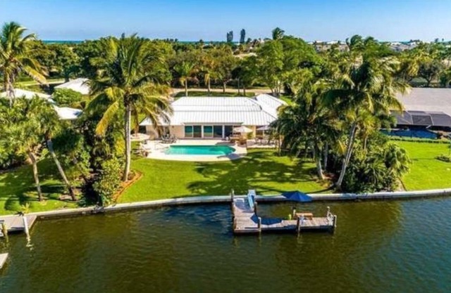 Waterfront 4 bdrm home w/pool, dock and beach access.