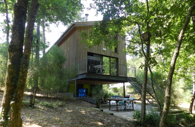 Wooden house in the golf, between forest, lake and ocean