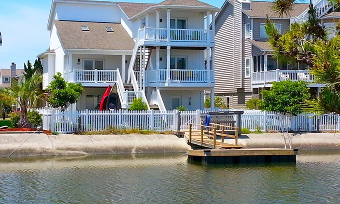 Ocean Isle Beach House | 4bd Canal Front home with an Elevator, dock, fenced back yard, 2 master suites