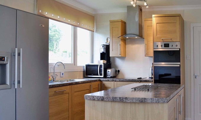 Tighnabruaich Cottage | A detached wooden bungalow, on an open elevated position facing east out to the Kyles of Bute.