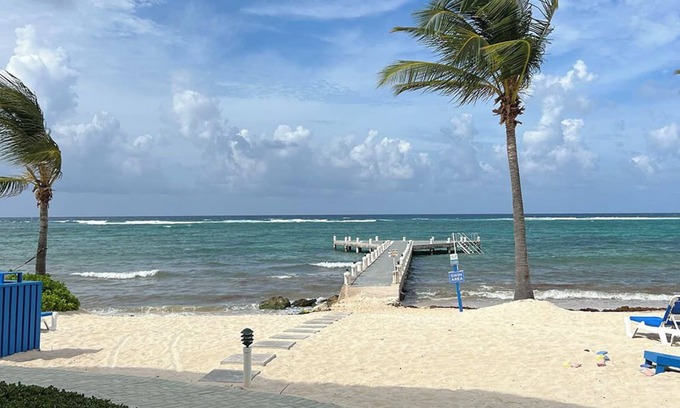Colliers Bay Apartment | Beautiful beach front spacious studio apartment with private oceanfront patio.