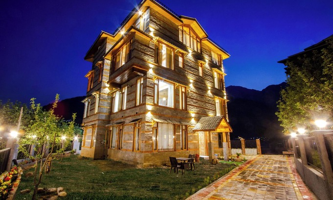 Manali Ski Chalet | Bedroom in a stone and wood chalet admist apple garden