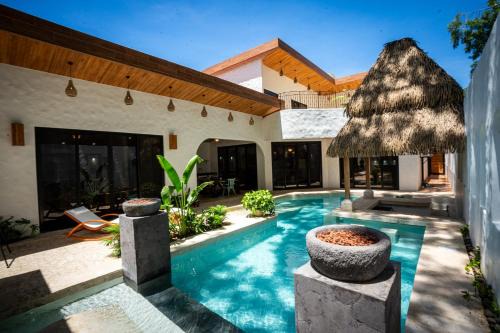 Potrero House | Bohemian Tropical Villa with a Tiki-Style Swimming Pool & Swim-Up Bar with an Attached Studio Apartment