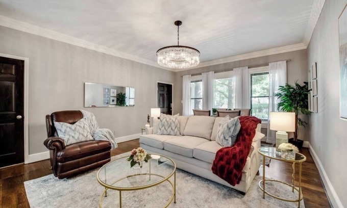 Old East Dallas Condo | Bright and luxurious 1-bedroom condo combining historic charm with modern comfort. Features a spacious living area with elegant furnishings, crystal lighting, and abundant natural light for a refined Dallas stay.