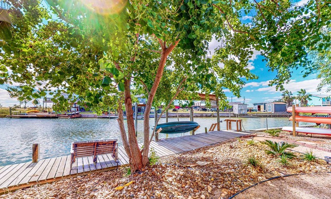 Rockport House | Canal-front retreat with dock/bay access, hot tub, covered deck, kayaks, & AC