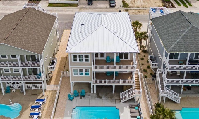 Ocean Isle Beach House | Carefree Highway is a breathtaking 5-bedroom, 5-bathroom home in Ocean Isle Beach, offering stunning ocean views, a private pool, and an elevator!