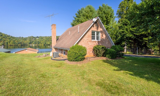 Ingles House | Charming lakefront retreat with cozy interiors, private dock, fire pit, and breathtaking water view