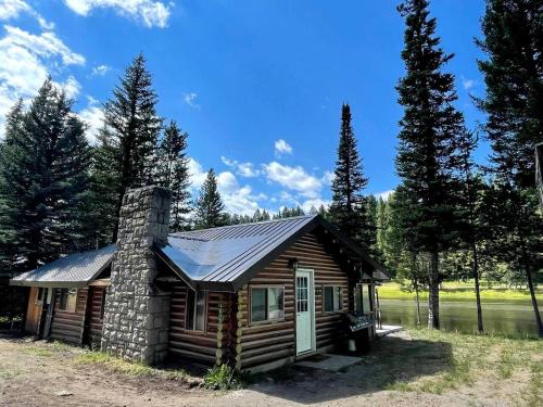 Island Park House | Charming Riverfront Cabin with Hot Tub and Dock Access Near Scenic Trails in Island Park, Idaho