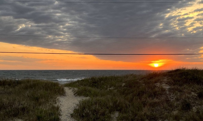 Kitty Hawk House | Classic, semi ocean front OBX cottage steps away from the beach.