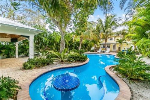 Anna Maria House | Coconut Lagoon - Lovely Historic Renovated Cottage wHuge Heated Pool Backyard OasisCabanaBar