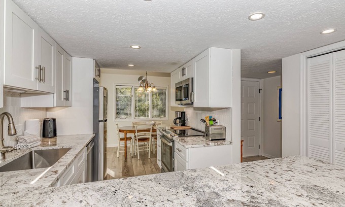 Bald Head Island Condo | Condo with community pool and balcony with forest view, recently renovated