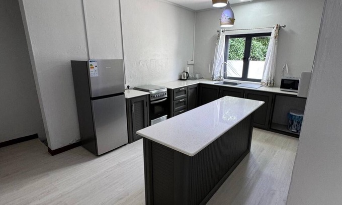 Roches Noires House | Cozy 2 bed-room house with beautiful front yard; 15 minutes to the beach.