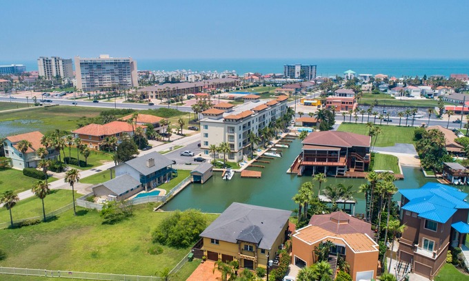 South Padre Island Condo | Cozy Condo on the Canal! Boat Slip, Heated Pool & Water Views - Walk to Clayton's!