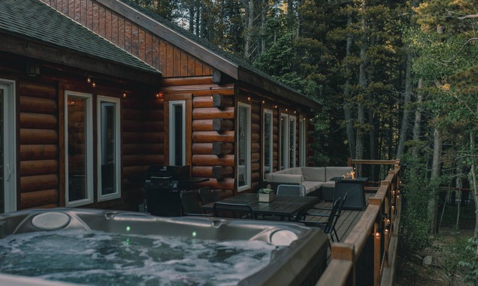 Saint Mary's Cabin | Cozy Log Cabin: hot tub under the stars, private deck, king bed, dog friendly!