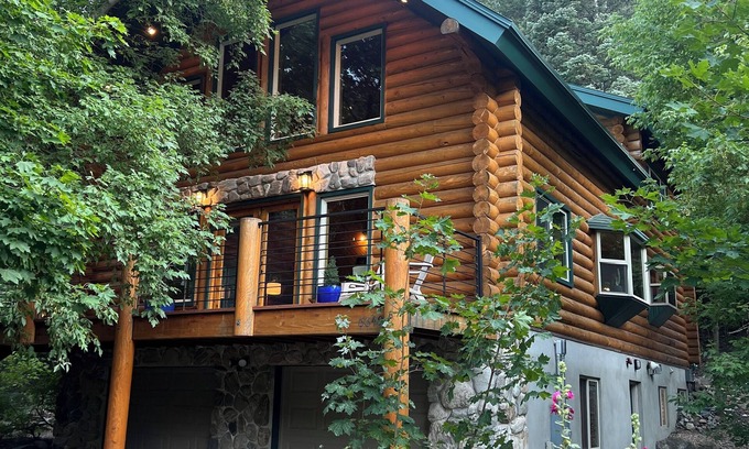 Snowbird Cabin | Cozy log cabin secluded in a mountain forest with hot tub, sauna, private patio.