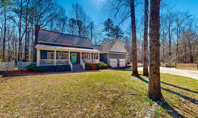 Forsyth House | Creekside home with firepit, yard games, deck, wood stove, & W/D