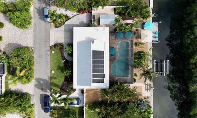 Whitney Beach House | Cute canal front Cottage with dock & boat lift and pool ,short walk to the beach