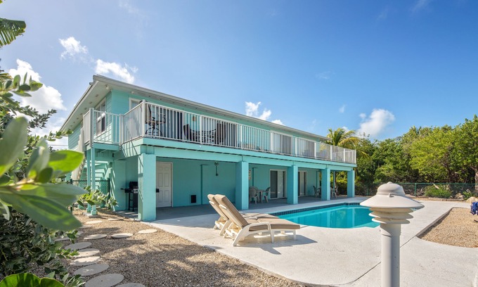 Marathon House | Dog-friendly, canal-front home with seawall dock, heated pool & gas grills