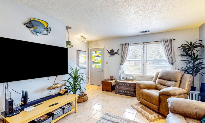 Atlantic Beach Condo | Dog-friendly coastal retreat with games, W/D, & patio - walk to the beach